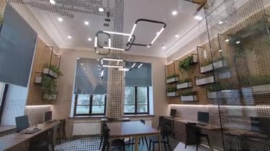 Empty coworking with computers on comfortable workplaces
