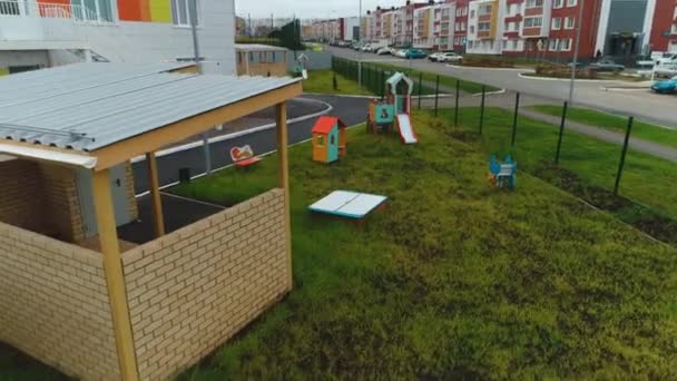 Playground with arbor and attractions near kindergarten — стоковое видео