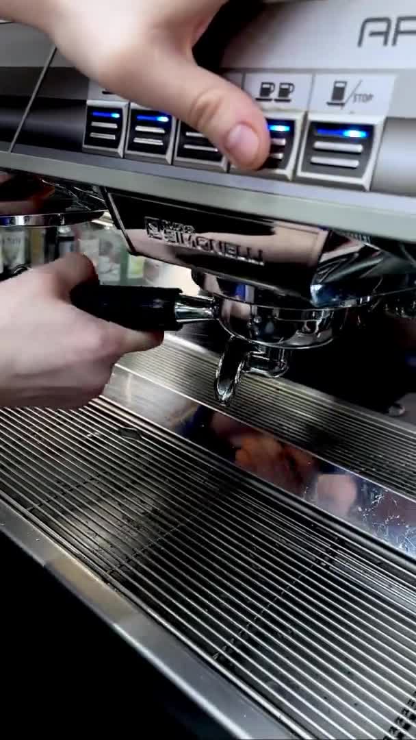 Barman puts portafilter and cup to coffee machine in cafe — Stock videók