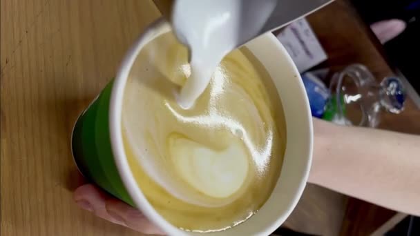 Bartender draws moon with heart with cream in cup of coffee — Stock videók