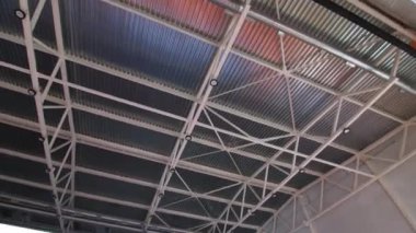Uçsuz bucaksız koridor tavanında kurşun lambalar olan bir iskelet.