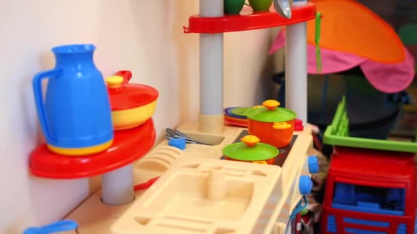 Set of plastic toy dishes and stove in kindergarten playroom — Stock Video