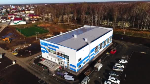 Sports complex with parking site and football field at dusk — Stock Video