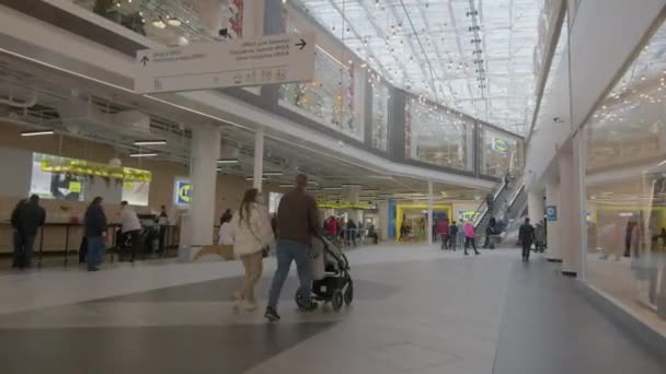 Hombre y mujer con bebé paseo en buggy a lo largo del centro comercial — Vídeos de Stock