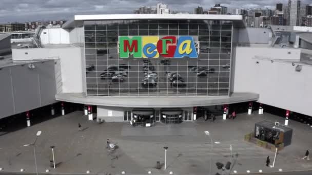 Parkovací místo se odráží v zrcadlové fasádě obchodního centra Mega — Stock video