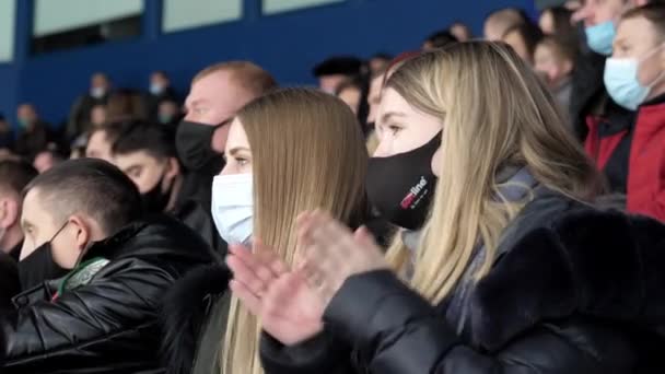 Donna con maschera batte le mani vicino ragazza amico a hockey gioco — Video Stock