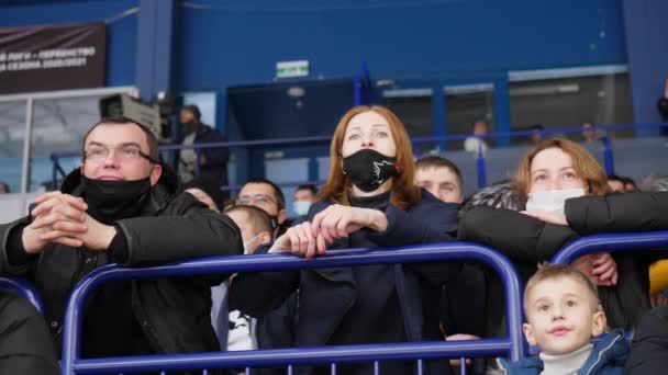 Эмоциональная женщина с друзьями в масках смотрит игру — стоковое видео