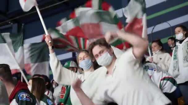 Feliz joven baila con amigos en la tribuna en el hockey — Vídeos de Stock