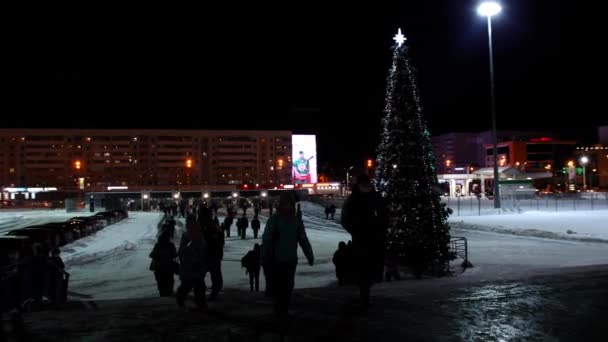 La gente camina cerca de árbol de Navidad camarógrafo dispara hockey — Vídeos de Stock