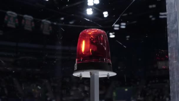 Red flashlight blinks on ice rink woman supports hockey team — Stock Video
