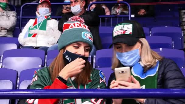Mulheres fãs de esportes com equipe favorita merch olhar para o telefone — Vídeo de Stock