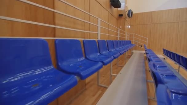 Empty plastic chairs for sports fans on spectator places — Stock Video
