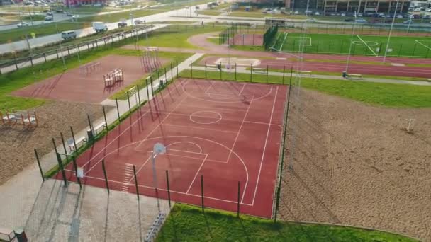 Порожній баскетбольний майданчик з парканом на території спортивного центру. — стокове відео