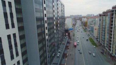 Çağdaş şehir hava manzaralı, farklı araçları ve çok katlı şık apartmanı olan uzun cadde yolu.