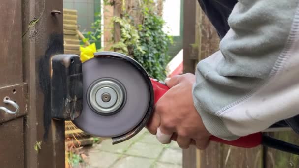 Man Cuts Lock Door Grinder Grinder Sparks — Stock Video