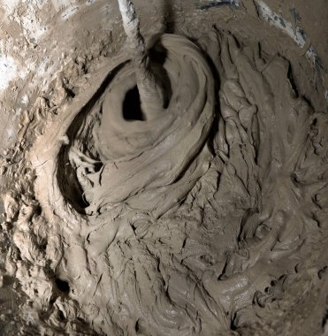 Industry background. Construction site. Mixing tile adhesive with a construction mixer