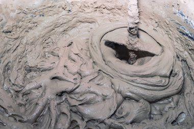 Industry background. Construction site. Mixing tile adhesive with a construction mixer