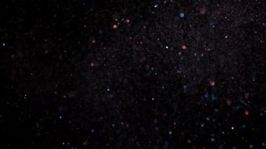 Parlayan parçacıkların ve kıvılcımların arka planı. Etkinlik, festival, sunum, müzik, şov, parti, ödül, moda, festival, kulüp ve sahne için sihirli arkaplan