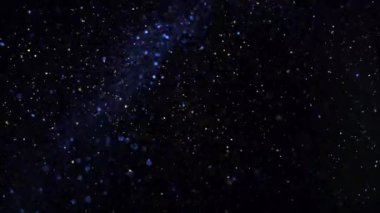 Parlayan parçacıkların ve kıvılcımların arka planı. Etkinlik, festival, sunum, müzik, şov, parti, ödül, moda, festival, kulüp ve sahne için sihirli arkaplan