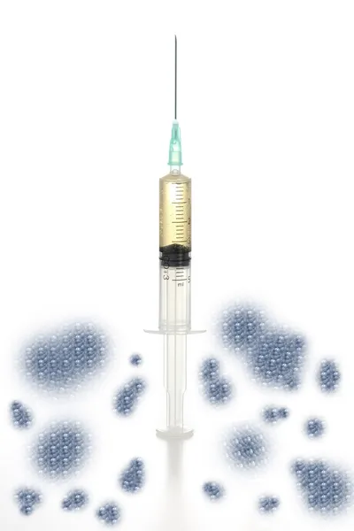 Syringe placed vertically, cells at the bottom — Stock Photo, Image