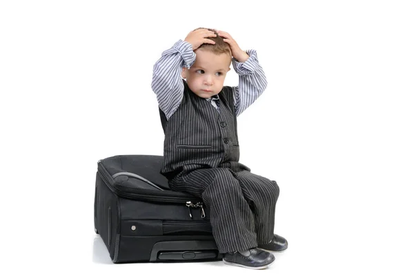 Little boy sitting on a suitcase — Stock Photo, Image