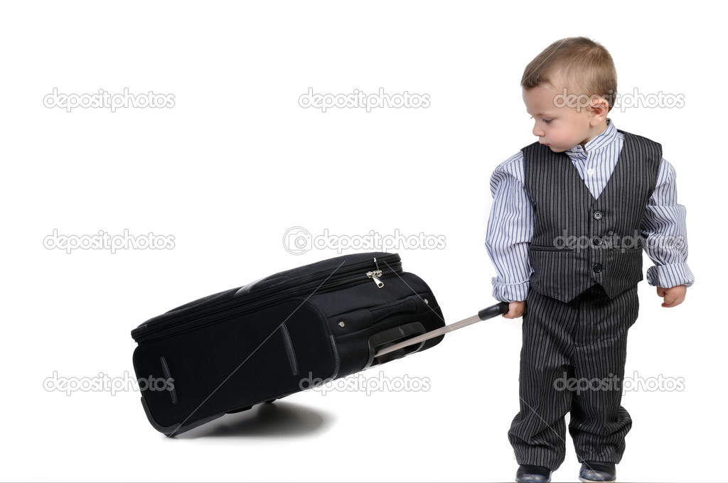 small boy carrying a suitcase