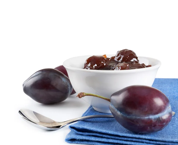 Ripe plums, jam and spoon — Stock Photo, Image