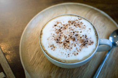 Kapuçino ya da köpüklü latte kahve, üzerinde kahve fincanı, klasik klasik kahve saati.