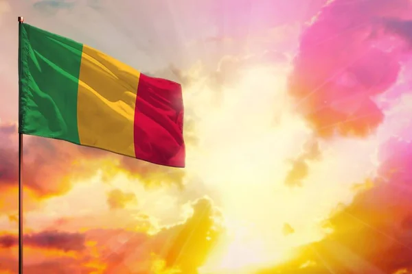 Fluttering Mali flag in left top corner mockup with the place for your information on beautiful colorful sunset or sunrise background.