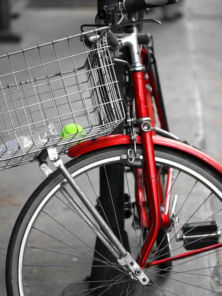 An old and red bicycle in the street — Stock Photo, Image