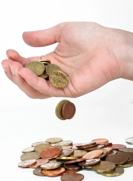 Some euro coins falling from a human hand — Stock Photo, Image