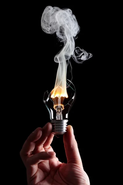 Лампочка и огонь — стоковое фото