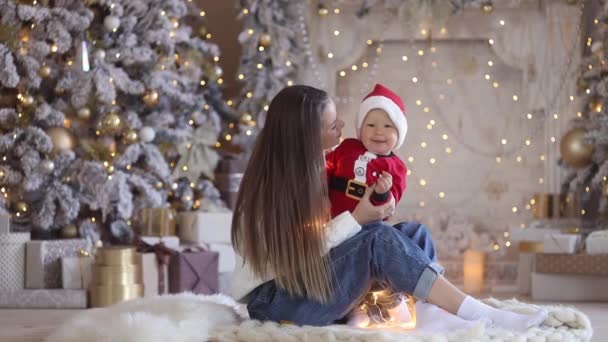 Belle jeune famille : mère jouant avec son petit garçon près de l'arbre de Noël — Video