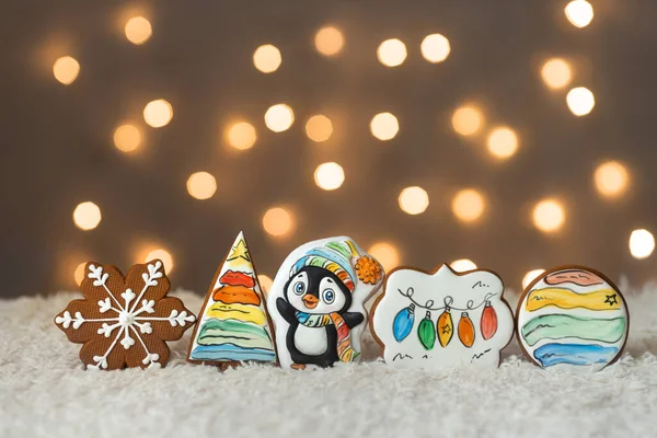 Christmas cute set of cinnamon gingerbread cookies for kids on background of garlands warm bokeh lights — Stock Photo, Image