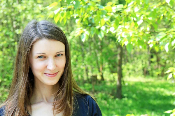 Young beautiful girl on a background of green vegetation — Stock Photo, Image