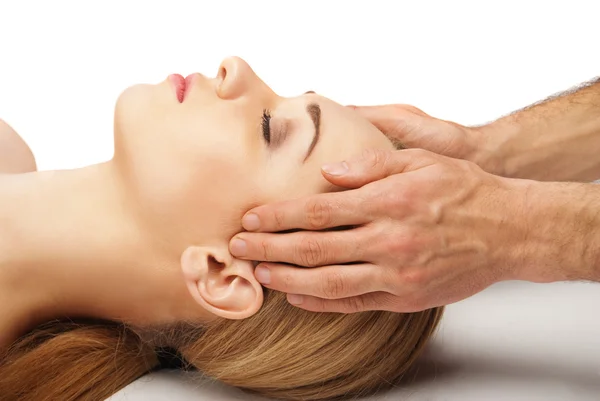 Young woman receiving a head massage on white — Stock Photo, Image