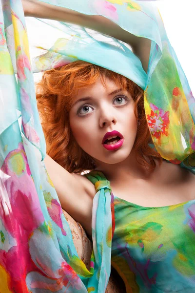 Girl with red hair and colorful dress over white — Stock Photo, Image