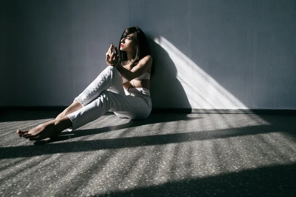 Kvinna som bär vita jeans och lingery liggande — Stockfoto