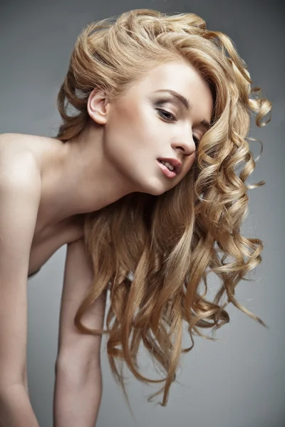 Sensual woman with shiny curly long blond hair — Stock Photo, Image