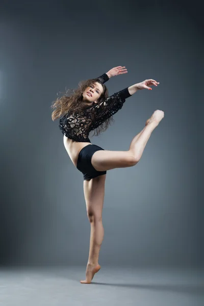 Moderni tyyli tanssija poseeraa harmaalla taustalla — kuvapankkivalokuva