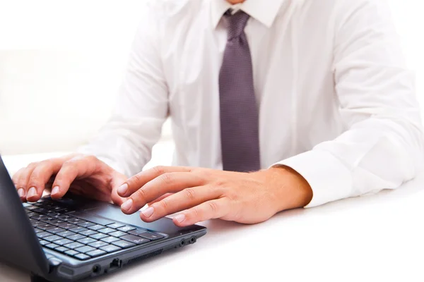 Businessman working on laptop over white — Stock Photo, Image