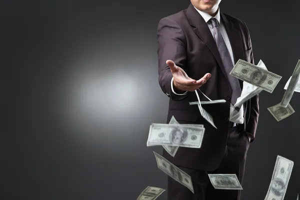 Handsome young man throwing money — Stock Photo, Image