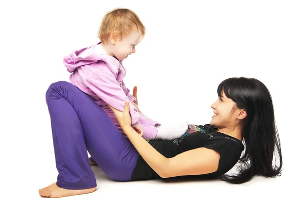 Mother with the baby doing exercises over white — Stock Photo, Image