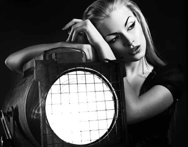 Sexy young woman with old floodlight — Stock Photo, Image