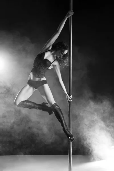 Young slim pole dance woman exercising over dark — Stock Photo, Image