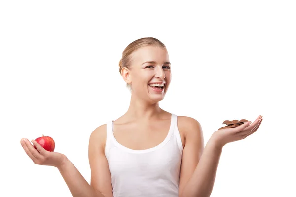 Woman holding apple and chocolate isolated — Stock Photo, Image