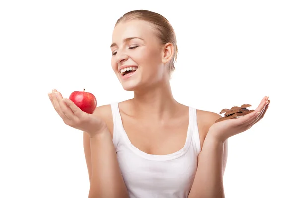 Woman holding apple and chocolate isolated — Stock Photo, Image
