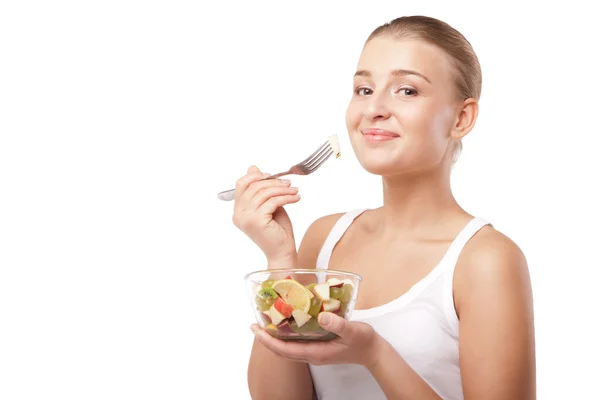 Menina bonita comer salada de frutas isolado — Fotografia de Stock