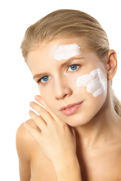Woman applying moisturizer cream on face isolated — Stock Photo, Image