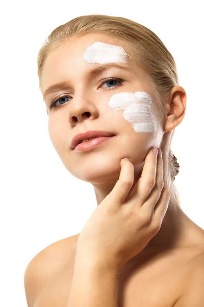 Woman applying moisturizer cream on face isolated — Stock Photo, Image